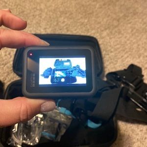GoPro with case and accessory kit. Includes a 2nd battery.